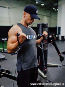 Fitness enthusiast executing cable curls in the gym, targeting biceps. Standing upright, holding cable handles